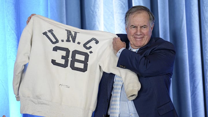 Dec 12, 2024; Chapel Hill, NC, USA;   North Carolina Tar Heels new head coach Bill Belichick holds up the sweatshirt worn by his father when he was an assistant coach at New North Carolina Tar Heels new at Loudermilk Center for Excellence.