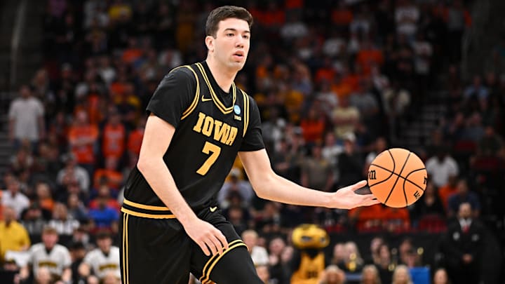 Mar 28, 2026; Houston, TX, USA; Iowa Hawkeyes forward Alvaro Folgueiras (7) controls the ball against the Illinois Fighting Illini in the first half during an Elite Eight game of the South Regional of the men's 2026 NCAA Tournament at Toyota Center. Mandatory Credit: Maria Lysaker-Imagn Images Mar 28, 2026; Houston, TX, USA; Iowa Hawkeyes forward Alvaro Folgueiras (7) controls the ball against the Illinois Fighting Illini in the first half during an Elite Eight game of the South Regional of the men's 2026 NCAA Tournament at Toyota Center. Mandatory Credit: Maria Lysaker-Imagn Images