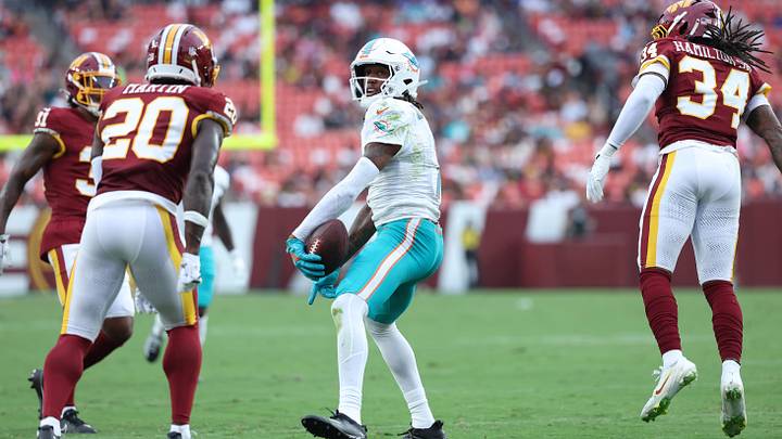 Miami Dolphins wide receiver Caleb Douglas (7) celebrates after making a catch during the first half against the Washington Commanders at Northwest Stadium. Miami Dolphins wide receiver Caleb Douglas (7) celebrates after making a catch during the first half against the Washington Commanders at Northwest Stadium.