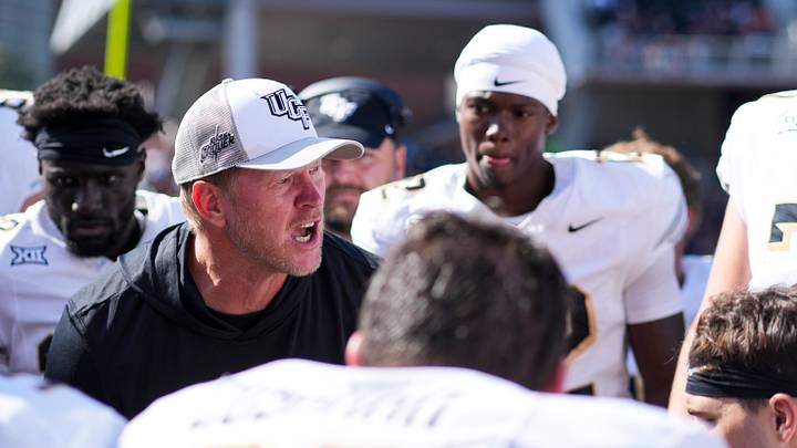 Oct 11, 2025; Cincinnati, Ohio, USA; UCF Knights head coach Scott Frost talks with his team on the sidelines in the game against the Cincinnati Bearcats in the second half at Nippert Stadium. Mandatory Credit: Aaron Doster-Imagn Images