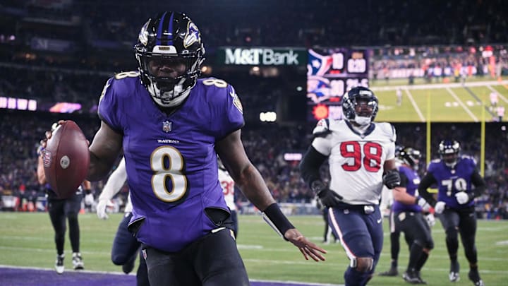 Jan 20, 2024; Baltimore, MD, USA; Baltimore Ravens quarterback Lamar Jackson (8) runs the ball to score a touchdown against Houston Texans defensive tackle Sheldon Rankins (98) during the fourth quarter of a 2024 AFC divisional round game at M&T Bank Stadium. Mandatory Credit: Tommy Gilligan-USA TODAY Sports