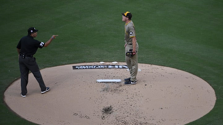 Jul 25, 2025; St. Louis, Missouri, USA;  San Diego Padres starting pitcher Nick Pivetta (27) argues with umpire Alfonso Marquez (72) after the benches cleared when he hit St. Louis Cardinals first baseman Willson Contreras (not pictured) with a pitch during the second inning at Busch Stadium. Mandatory Credit: Jeff Curry-Imagn Images