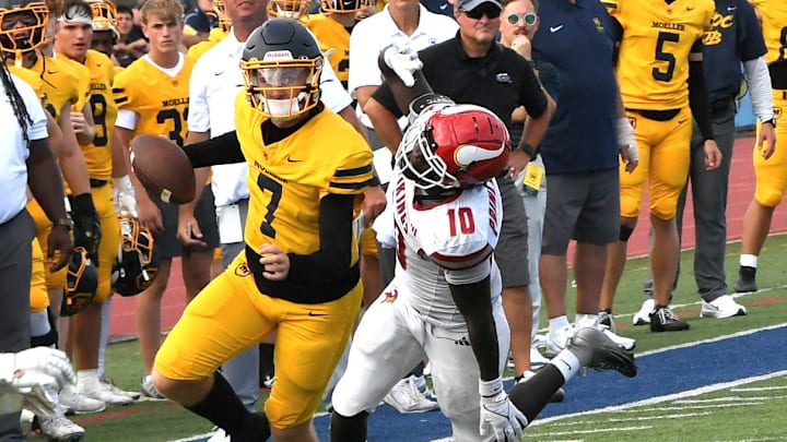 Matt Ponatoski scrambles for a Moeller first down at the Princeton vs. Moeller King of the Block rivalry football game, Aug. 23, 2025.