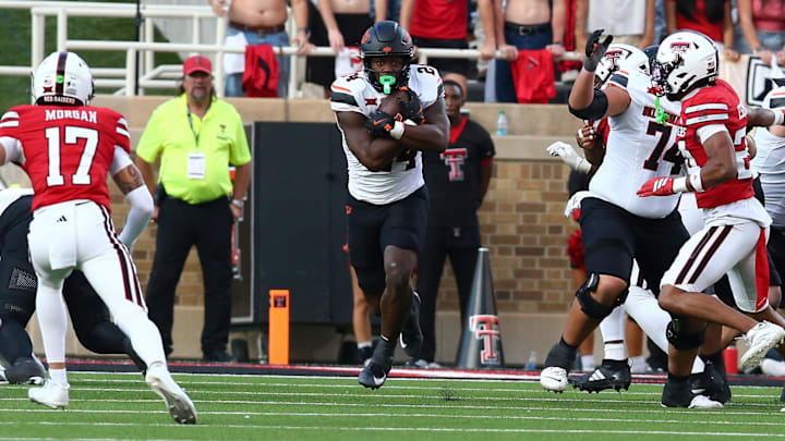 Oct 25, 2025; Lubbock, Texas, USA;  Oklahoma State Cowboys running back Trent Howland (24) rushes against the Texas Tech Red Raiders in the second half at Jones AT&T Stadium. Mandatory Credit: Michael C. Johnson-Imagn Images Oct 25, 2025; Lubbock, Texas, USA;  Oklahoma State Cowboys running back Trent Howland (24) rushes against the Texas Tech Red Raiders in the second half at Jones AT&T Stadium. Mandatory Credit: Michael C. Johnson-Imagn Images