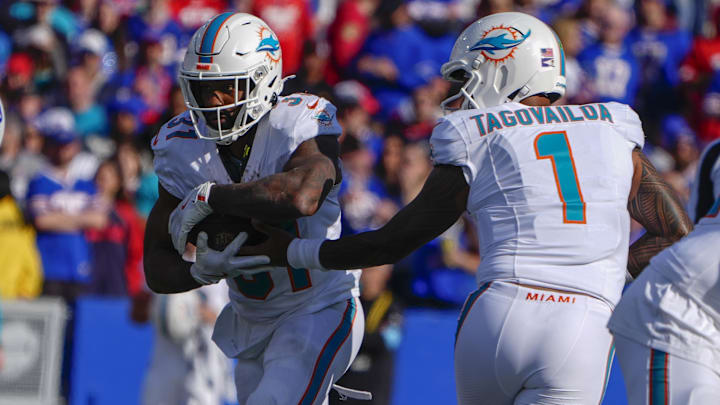 Nov 3, 2024; Orchard Park, New York, USA; Miami Dolphins quarterback Tua Tagovailoa (1) hands the ball off to Miami Dolphins running back Raheem Mostert (31) against the Buffalo Bills during the first half at Highmark Stadium. Mandatory Credit: Gregory Fisher-Imagn Images