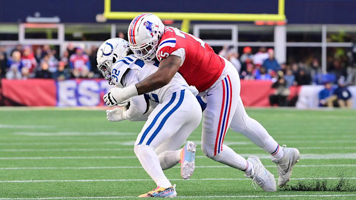 Dec 1, 2024; Foxborough, Massachusetts, USA; New England Patriots offensive tackle Demontrey Jacobs (75) tackles Indianapolis Colts safety Julian Blackmon (32) during the second half at Gillette Stadium. Mandatory Credit: Eric Canha-Imagn Images