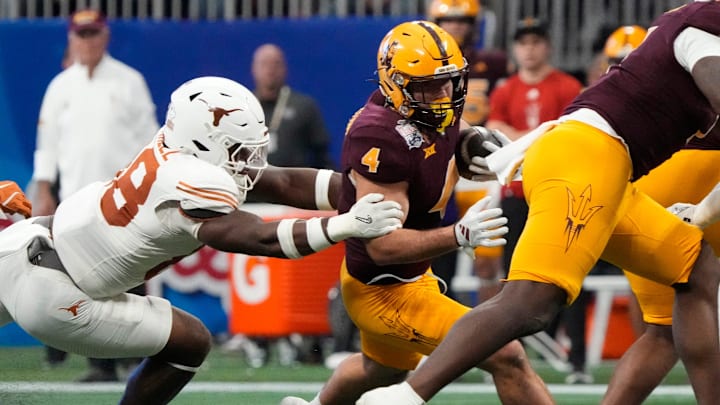 Arizona State running back Cam Skattebo (4) is tackled by Texas linebacker Barryn Sorrell (88) during the first quarter of the Chick-fil-A Peach Bowl in Atlanta on Wednesday, Jan. 1, 2025. Arizona State running back Cam Skattebo (4) is tackled by Texas linebacker Barryn Sorrell (88) during the first quarter of the Chick-fil-A Peach Bowl in Atlanta on Wednesday, Jan. 1, 2025.