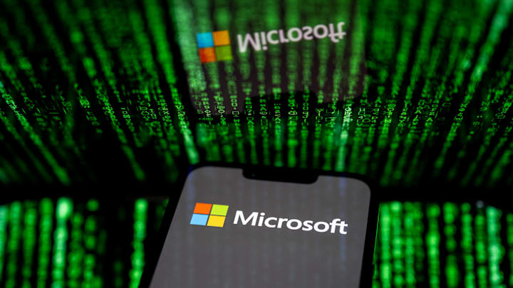 In this photo illustration, the Microsoft logo seen...