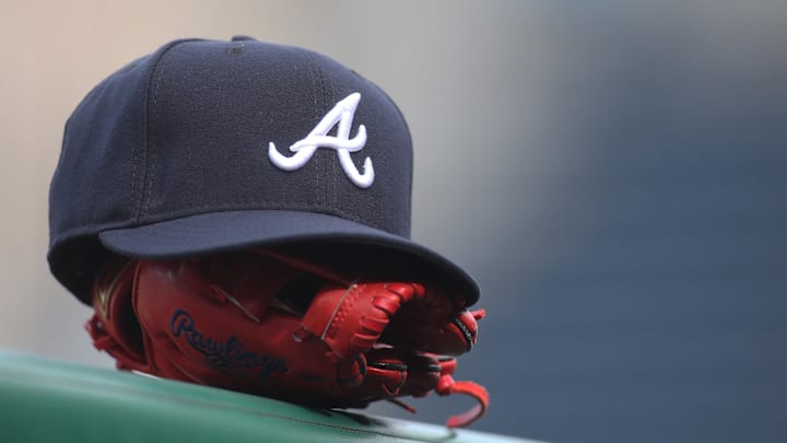 Jun 4, 2019; Pittsburgh, PA, USA; An Atlanta Braves hat and glove sit on the dugout rail before the game against the Pittsburgh Pirates at PNC Park. Atlanta won 12-5. Mandatory Credit: Charles LeClaire-Imagn Images Jun 4, 2019; Pittsburgh, PA, USA; An Atlanta Braves hat and glove sit on the dugout rail before the game against the Pittsburgh Pirates at PNC Park. Atlanta won 12-5. Mandatory Credit: Charles LeClaire-Imagn Images