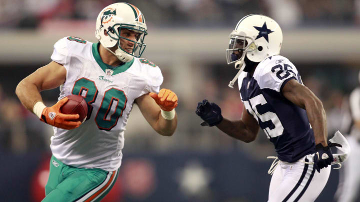 Tight end Anthony Fasano (80) runs after catching a pass against the Dallas Cowboys on Thanksgiving day at Cowboys Stadium in 2011.