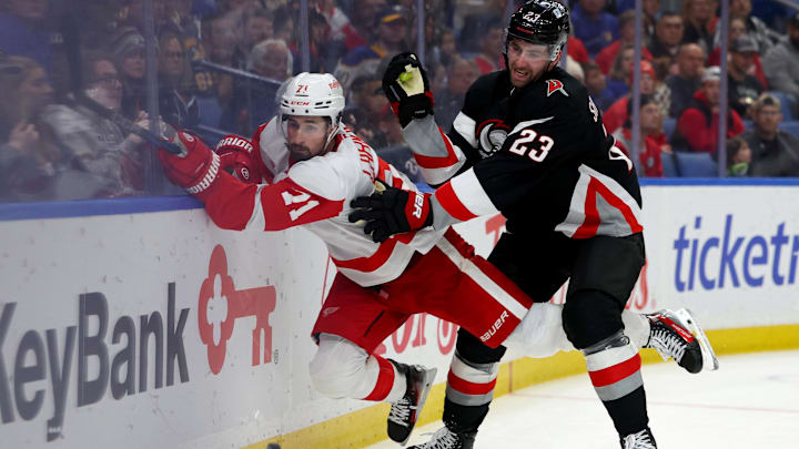 Oct 26, 2024; Buffalo, New York, USA;  Buffalo Sabres defenseman Mattias Samuelsson (23) checks Detroit Red Wings center Dylan Larkin (71) as he goes after the puck during the third period at KeyBank Center. Mandatory Credit: Timothy T. Ludwig-Imagn Images