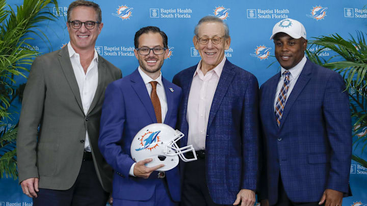 Miami Dolphins Vice Chairman, President and Chief Executive Officer Tom Garfinkel, new head coach Mike McDaniel, owner Stephen M. Ross, and general manager Chris Grier, are photographed during a press conference at Baptist Health Training Center in 2022. Miami Dolphins Vice Chairman, President and Chief Executive Officer Tom Garfinkel, new head coach Mike McDaniel, owner Stephen M. Ross, and general manager Chris Grier, are photographed during a press conference at Baptist Health Training Center in 2022.