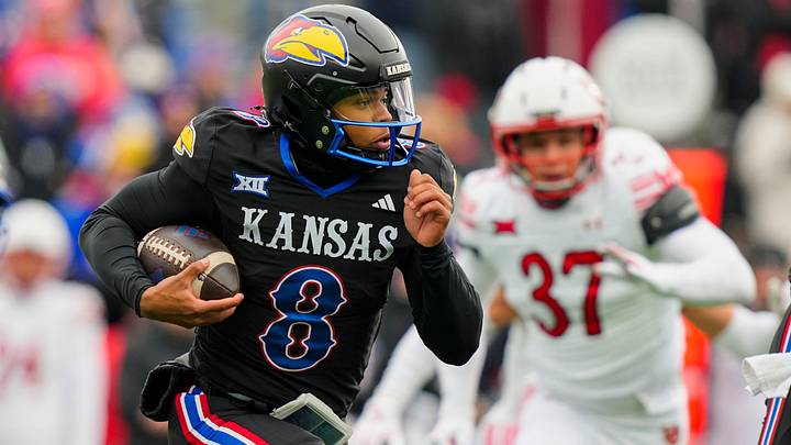 Nov 28, 2025; Lawrence, Kansas, USA; Kansas Jayhawks quarterback Isaiah Marshall (8) runs the ball during the first half against the Utah Utes at David Booth Kansas Memorial Stadium. Mandatory Credit: Jay Biggerstaff-Imagn Images Nov 28, 2025; Lawrence, Kansas, USA; Kansas Jayhawks quarterback Isaiah Marshall (8) runs the ball during the first half against the Utah Utes at David Booth Kansas Memorial Stadium. Mandatory Credit: Jay Biggerstaff-Imagn Images