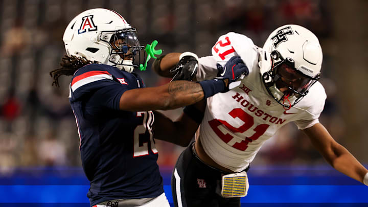 Nov 15, 2024; Tucson, Arizona, USA; Arizona Wildcats defensive back Marquis Groves-Killebrew (20) shoves Houston Cougars running back Stacy Sneed (21) during the third quarter at Arizona Stadium. Mandatory Credit: Aryanna Frank-Imagn Images Nov 15, 2024; Tucson, Arizona, USA; Arizona Wildcats defensive back Marquis Groves-Killebrew (20) shoves Houston Cougars running back Stacy Sneed (21) during the third quarter at Arizona Stadium. Mandatory Credit: Aryanna Frank-Imagn Images