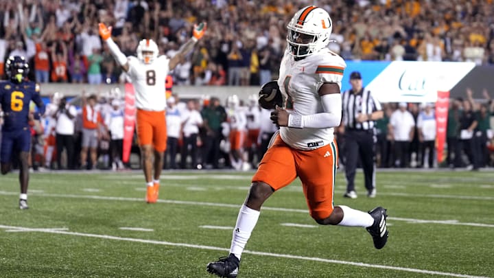 Oct 5, 2024; Berkeley, California, USA; Miami Hurricanes quarterback Cam Ward (1) rushes for a touchdown against the California Golden Bears during the fourth quarter at California Memorial Stadium. Mandatory Credit: Darren Yamashita-Imagn Images