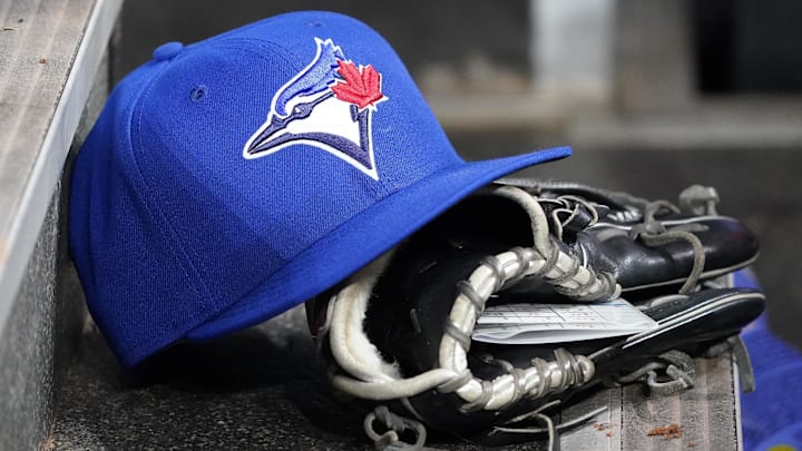Apr 16, 2025; Toronto, Ontario, CAN; A Toronto Blue Jays hat and glove in the dugout during a game against the Atlanta Braves at Rogers Centre. 