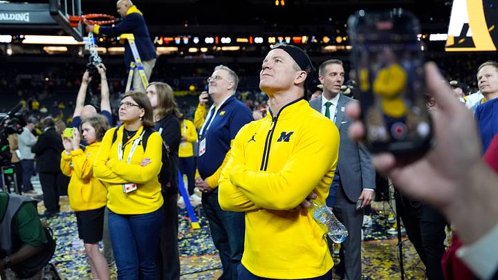 Michigan head coach Dusty May watches the Jumbotron during the NCAA national championship trophy after the team beat Connecticut at Lucas Oil Stadium in Indianapolis on Monday, April 6, 2026.