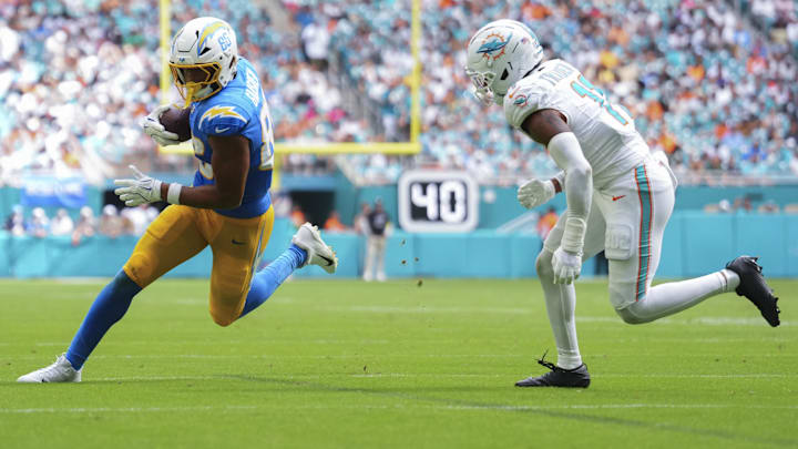 Los Angeles Chargers tight end Oronde Gadsden II (86) runs the ball against Miami Dolphins safety Dante Trader Jr. (11) during the third quarter at Hard Rock Stadium.