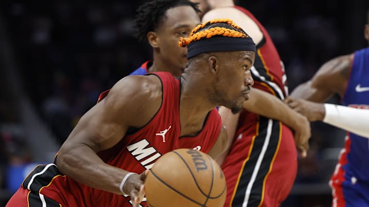 Dec 16, 2024; Detroit, Michigan, USA;  Miami Heat forward Jimmy Butler (22) is defended by Detroit Pistons forward Ronald Holland II (00) in the first half at Little Caesars Arena. Mandatory Credit: Rick Osentoski-Imagn Images