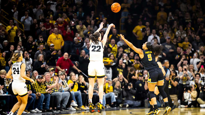 Iowa guard Caitlin Clark makes a 3-point basket setting the record for all-time leading scoring record.