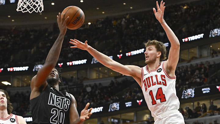 Dec 2, 2024; Chicago, Illinois, USA;  Brooklyn Nets center Day'Ron Sharpe (20) shoots against Chicago Bulls forward Matas Buzelis (14) during the second half at the United Center. Mandatory Credit: Matt Marton-Imagn Images