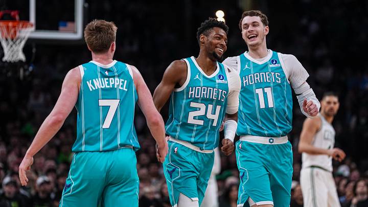 Charlotte Hornets center Ryan Kalkbrenner (11), forward Brandon Miller (24) and guard Kon Knueppel (7) react 