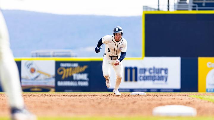 Penn State Nittany Lions baseball player Michael Anderson sprints to third base against the Iowa Hawkeyes. Penn State Nittany Lions baseball player Michael Anderson sprints to third base against the Iowa Hawkeyes.