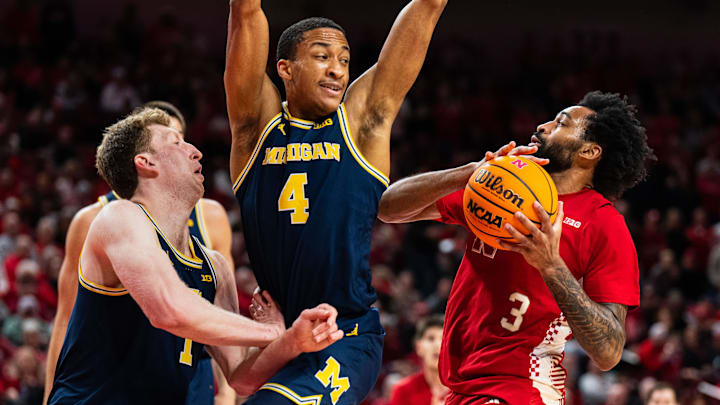 Feb 24, 2025; Lincoln, Nebraska, USA; Nebraska Cornhuskers guard Brice Williams (3) drives against Michigan Wolverines guard Nimari Burnett (4) and center Danny Wolf (1) during the first half at Pinnacle Bank Arena.