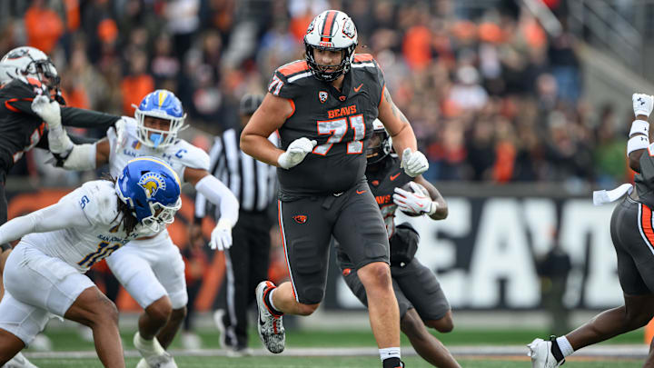 Nov 9, 2024; Corvallis, Oregon, USA; Oregon State Beavers offensive lineman Gerad Christian-Lichtenhan (71) pulls ahead of running back Salahadin Allah (26) during the second quarter against the San Jose State Spartans at Reser Stadium. Mandatory Credit: Craig Strobeck-Imagn Images Nov 9, 2024; Corvallis, Oregon, USA; Oregon State Beavers offensive lineman Gerad Christian-Lichtenhan (71) pulls ahead of running back Salahadin Allah (26) during the second quarter against the San Jose State Spartans at Reser Stadium. Mandatory Credit: Craig Strobeck-Imagn Images