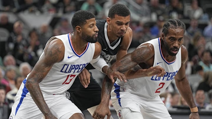 Los Angeles Clippers forwards Paul George (13) and Kawhi Leonard (2) box out San Antonio Spurs forward Victor Wembanyama (1) during the second half at Frost Bank Center. Mandatory Credit: Scott Wachter-Imagn Images