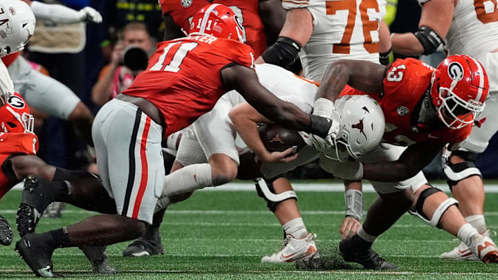 Georgia linebacker Jalon Walker (11) and Georgia defensive lineman Mykel Williams (13) take down Texas quarterback Quinn Ewers (3) during the second half of the SEC championship game against Texas in Atlanta, on Saturday, Dec. 7, 2024. Georgia linebacker Jalon Walker (11) and Georgia defensive lineman Mykel Williams (13) take down Texas quarterback Quinn Ewers (3) during the second half of the SEC championship game against Texas in Atlanta, on Saturday, Dec. 7, 2024.