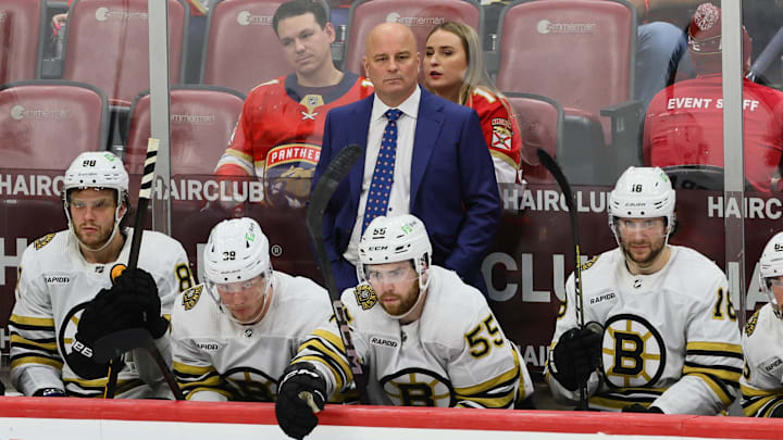 May 6, 2024; Sunrise, Florida, USA; Boston Bruins head coach Jim Montgomery watches from the bench against the Florida Panthers during the third period in game one of the second round of the 2024 Stanley Cup Playoffs at Amerant Bank Arena. Mandatory Credit: Sam Navarro-Imagn Images