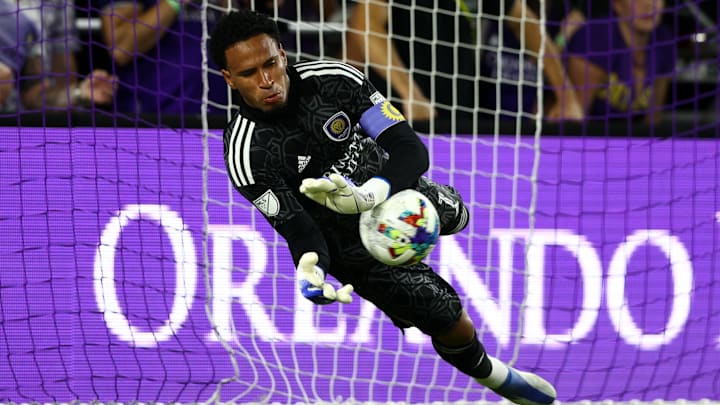 Jun 29, 2022; Orlando, FL, USA;  Orlando City goalie Alex Freeman (30) saves a penalty kick from Nashville SC defender Eric Miller (15) at the end of extra time at Exploria Stadium. Mandatory Credit: Nathan Ray Seebeck-Imagn Images