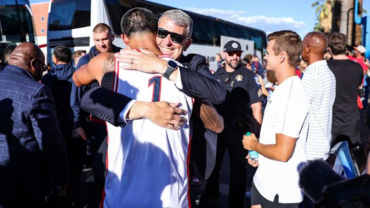 Aug 30, 2025; Tucson, Arizona, USA; Arizona Wildcats head coach Brent Brennan hugs Carolina Panthers wide receiver Tetairoa McMillan (4) before the game against the Hawaii Rainbow Warriors at Arizona Stadium. Mandatory Credit: Aryanna Frank-Imagn Images