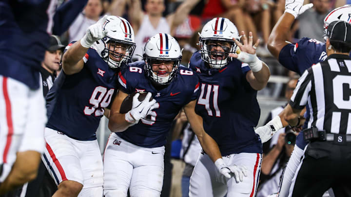 Aug 30, 2025; Tucson, Arizona, USA; Arizona Wildcats defensive lineman Mays Pese (99), linebacker Taye Brown (6), and defensive lineman Julian Saviinaea (41) all celebrate after they intercept the ball from the Hawaii Rainbow Warriors during the third quarter of the game at Arizona Stadium. Mandatory Credit: Aryanna Frank-Imagn Images414