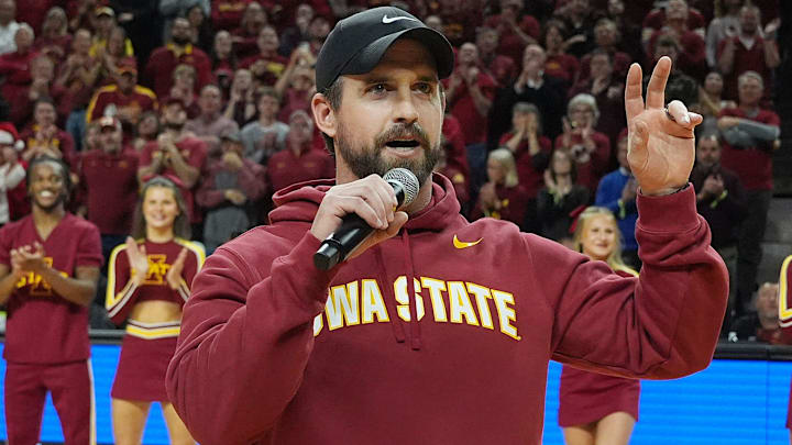 Iowa State football coach Jimmy Rogers speaks during a timeout in the Cy-Hawk men's basketball game on Dec. 11, 2025, at Hilton Coliseum in Ames. Iowa State football coach Jimmy Rogers speaks during a timeout in the Cy-Hawk men's basketball game on Dec. 11, 2025, at Hilton Coliseum in Ames.
