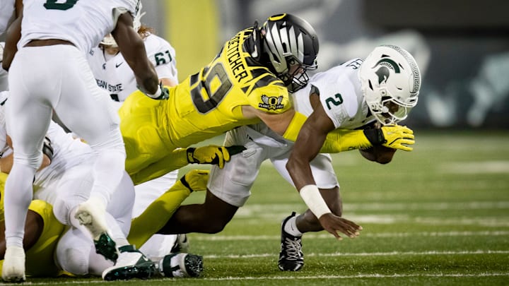Oregon Ducks inside linebacker Bryce Boettcher tackles Michigan State Spartans quarterback Aidan Chiles as the Ducks host the Spartans Friday, Oct. 4, 2024 at Autzen Stadium in Eugene, Ore. Oregon Ducks inside linebacker Bryce Boettcher tackles Michigan State Spartans quarterback Aidan Chiles as the Ducks host the Spartans Friday, Oct. 4, 2024 at Autzen Stadium in Eugene, Ore.