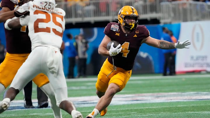 Arizona State running back Cam Skattebo (4) runs against Texas defensive back Jelani McDonald (25) during the third quarter of the Chick-fil-A Peach Bowl in Atlanta on Jan. 1, 2025.
