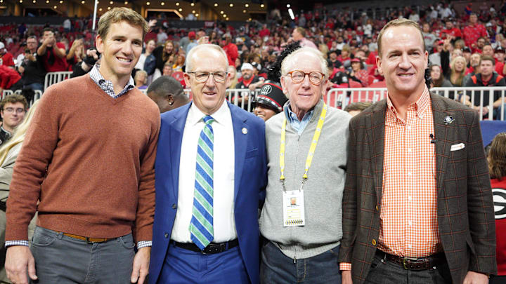 Dec 3, 2022; Atlanta, GA, USA; (L to R) Former NFL quarterbacks Eli Manning, Archie Manning, and Peyton Manning pose with SEC Commissioner Greg Sankey (2nd Left) prior to the SEC Championship game between the Georgia Bulldogs and the LSU Tigers at Mercedes-Benz Stadium. Mandatory Credit: Brett Davis-Imagn Images