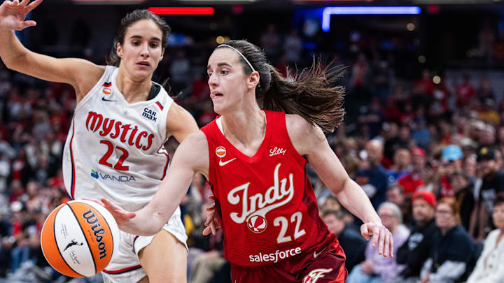 Indiana Fever guard Caitlin Clark (22) dribbles the ball while Washington Mystics guard Sonia Citron (22) 