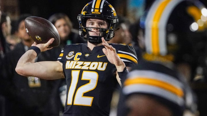 Nov 18, 2023; Columbia, Missouri, USA; Missouri Tigers quarterback Brady Cook (12) warms up against the Florida Gators prior to a game at Faurot Field at Memorial Stadium. Mandatory Credit: Denny Medley-USA TODAY Sports