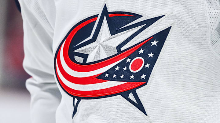 Mar 12, 2024; Montreal, Quebec, CAN; View of a Columbus Blue Jackets logo on a jersey worn by a member of the team during warm-up before the game against the Montreal Canadiens at Bell Centre. Mandatory Credit: David Kirouac-Imagn Images