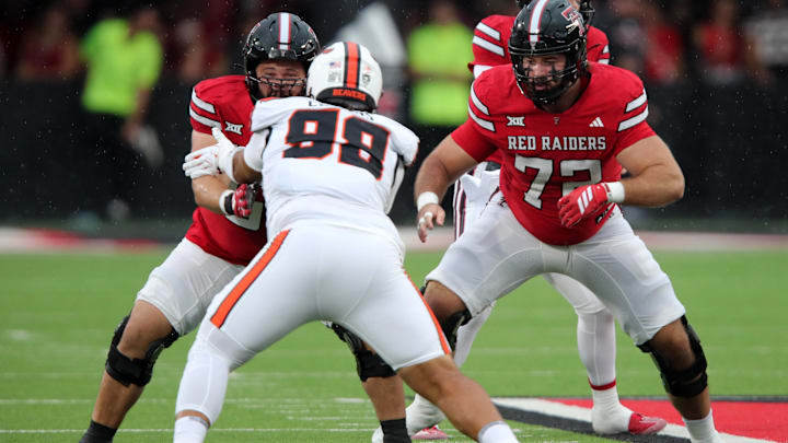 Sep 13, 2025; Lubbock, Texas, USA;  Texas Tech Red Raiders offensive lineman Davion Carter (56) and offensive lineman Sheridan Wilson (76) block Oregon State Beavers defensive tackle Thomas Collins (98) in the first half at Jones AT&T Stadium. Mandatory Credit: Michael C. Johnson-Imagn Images