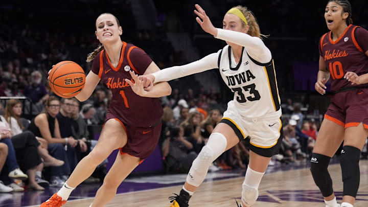 Nov 10, 2024; Charlotte, N.C.; Virginia Tech guard Carleigh Wenzel (1) tries to get past Iowa guard Lucy Olsen (33).