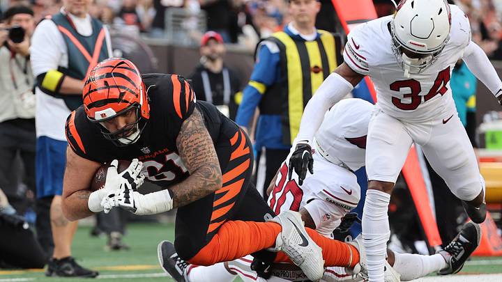 Dec 28, 2025; Cincinnati, Ohio, USA; Cincinnati Bengals guard Cody Ford (61) runs against Arizona Cardinals cornerback Darren Hall (30) and safety Jalen Thompson (34) during the second half at Paycor Stadium. Mandatory Credit: Joseph Maiorana-Imagn Images Dec 28, 2025; Cincinnati, Ohio, USA; Cincinnati Bengals guard Cody Ford (61) runs against Arizona Cardinals cornerback Darren Hall (30) and safety Jalen Thompson (34) during the second half at Paycor Stadium. Mandatory Credit: Joseph Maiorana-Imagn Images