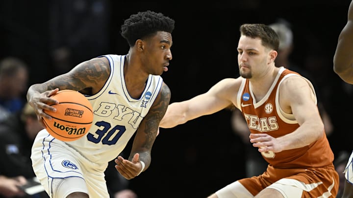Mar 19, 2026; Portland, OR, USA; BYU Cougars guard Kennard Davis Jr. (30) dribbles against Texas Longhorns forward Camden Heide (5) in the second half during a first round game of the men's 2026 NCAA Tournament at Moda Center. Mandatory Credit: Craig Strobeck-Imagn Images