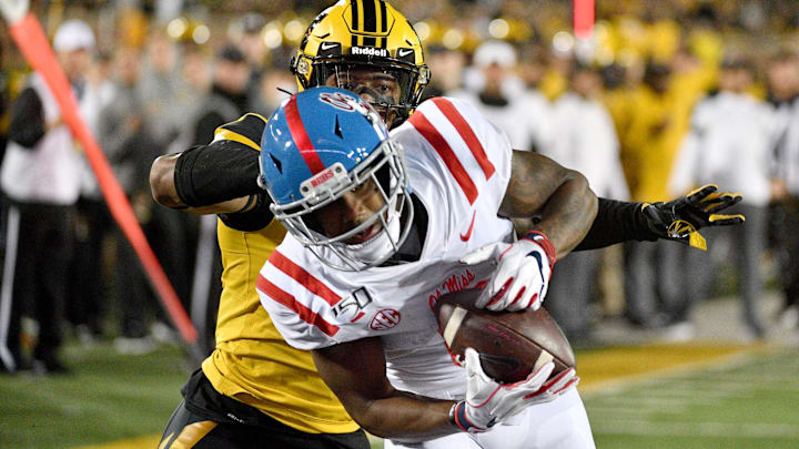 Oct 12, 2019; Columbia, MO, USA; Mississippi Rebels wide receiver Elijah Moore (8) scores as Missouri Tigers safety Joshuah Bledsoe (18) attempts the tackle during the second half at Memorial Stadium/Faurot Field. Mandatory Credit: Denny Medley-Imagn Images