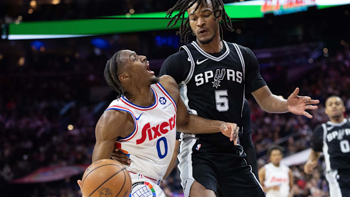 Dec 23, 2024; Philadelphia, Pennsylvania, USA; Philadelphia 76ers guard Tyrese Maxey (0) drives against San Antonio Spurs guard Stephon Castle (5) during the second quarter at Wells Fargo Center. Mandatory Credit: Bill Streicher-Imagn Images