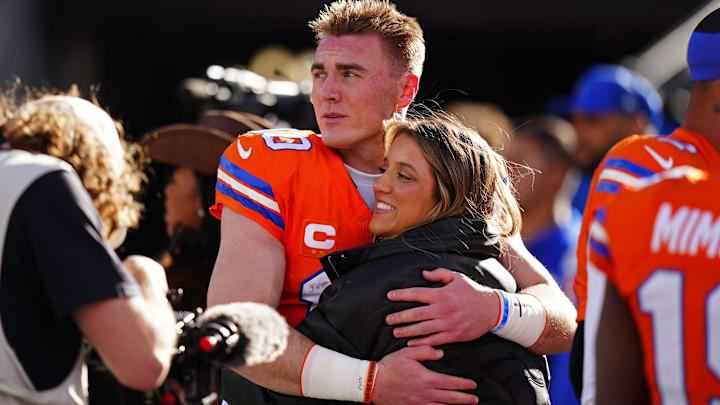 Jan 4, 2026; Denver, Colorado, USA; Denver Broncos quarterback Bo Nix (10) hugs wife, Izzy Nix before the game against the Los Angeles Chargers at Empower Field at Mile High.