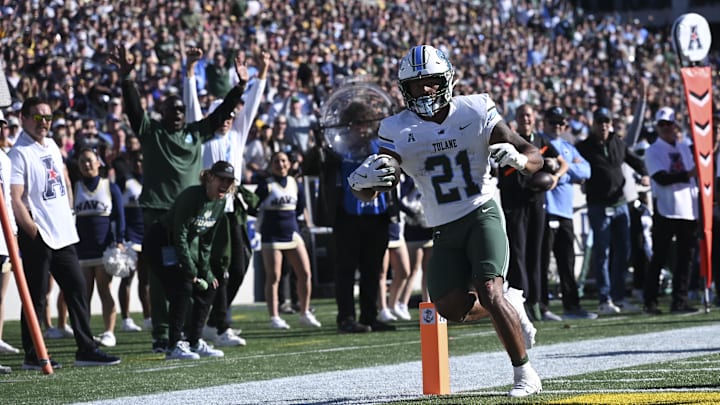 Nov 16, 2024; Annapolis, Maryland, USA;  Tulane Green Wave running back Makhi Hughes (21) scores a touchdown during the first half against the Navy Midshipmen at Navy-Marine Corps Memorial Stadium. Mandatory Credit: Tommy Gilligan-Imagn Images